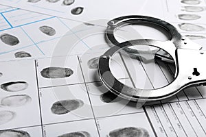 Handcuffs and fingerprint record sheets. Criminal investigation