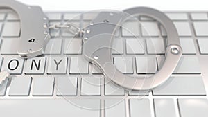 Handcuffs on keyboard with FELONY text. Computer crime related conceptual 3D animation