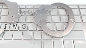 Handcuffs on keyboard with SPYING text on keys. Computer crime related conceptual 3D animation