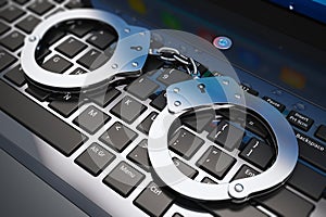 Handcuffs on laptop keyboard