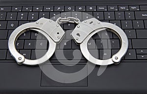 Handcuffs on laptop keyboard