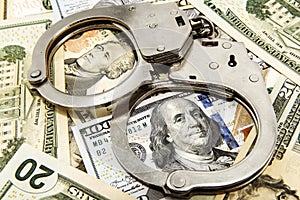 Handcuffs and money close-up. Financial fraud and crime. Handcuffs. Law and order