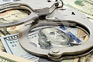 Handcuffs and money close-up. Financial fraud and crime. Handcuffs. Law and order