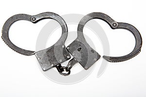 Handcuffs on a white background. Concept of crime and punishment