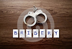 Handcuffs and the word of Bribery photo