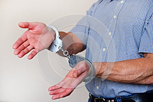 Handcuffs on the wrists of the detained man