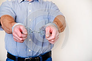 Handcuffs on the wrists of the detained man photo