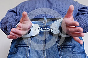 Handcuffs on the wrists of the detained man