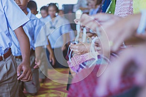 Handfasting. Selective focus on hands of Thai graduation ceremon