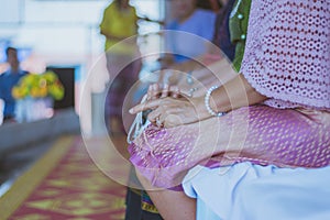 Handfasting. Selective focus on hands of Thai graduation ceremony.