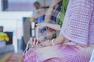 Handfasting. Selective focus on hands of Thai graduation ceremony.