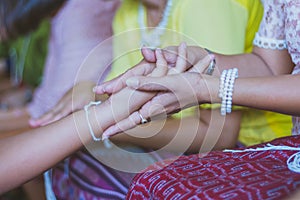 Handfasting. Selective focus on hands of Thai graduation ceremony.