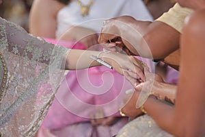 Handfasting. Selective focus on hands of Thai wedding ceremony.
