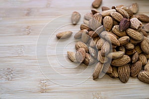 a handful of almonds on a wooden board