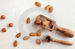 A handful of almonds in a wooden scoop. Healthy snack. Nuts