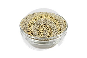 A handful of canary grass seed in a glass bowl