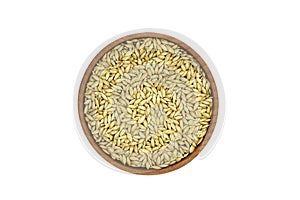 A handful canary grass seeds in a wooden bowl