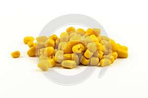 Handful of canned corn on white isolated background