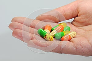 A handful of colorful capsules