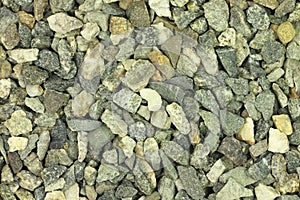 A handful of construction gravel gray background