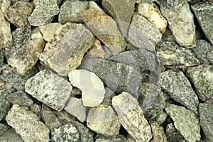 A handful of crushed gravel construction background