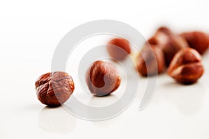 A handful of hazelnuts on a white background