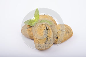 A handful of homemade croquettes of spinach isolated on white