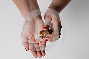 A handful of pills are poured into the girl`s hand