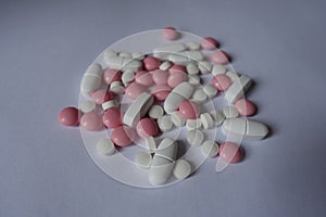 Handful of pink and white pills