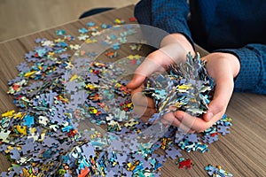 Handful of puzzles in hands of a teenager