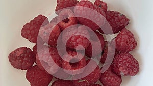 A handful of Raspberries in a bowl