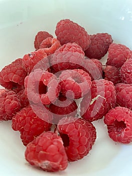 A handful of Raspberries in a bowl