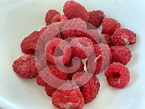 A handful of Raspberries in a bowl