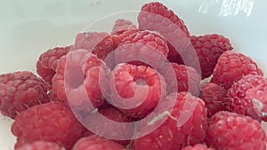 A handful of Raspberries in a bowl