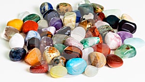 Handful of various gem stones on white