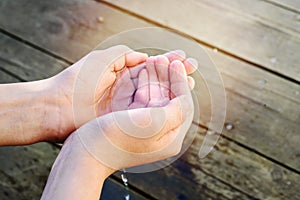 Handful of water in the hands of a child