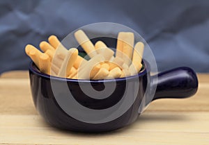 Handfull of short thin white crispy bread breadsticks