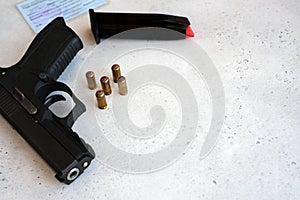 A handgun with bullets symbolizing gun rights while framed against the United States constitution.