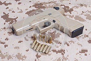 handgun on camouflage uniform