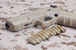 handgun on camouflage uniform