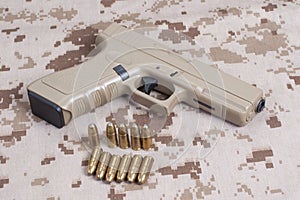 handgun on camouflage uniform