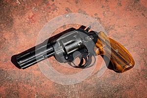 Handgun on the concrete red backgroound