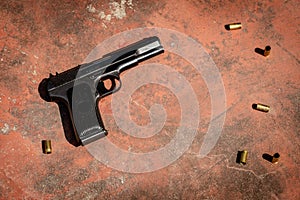 Handgun on the concrete red backgroound