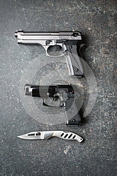 Handguns and offensive knife