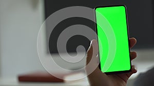 Handheld Camera: Point of View of Man at Modern Room Sitting on a Chair Using Phone With Green Mock-up Screen Chroma Key