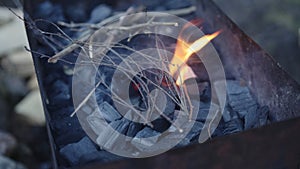 Handheld shot of charcoal in brazier, preparation for bbq photo