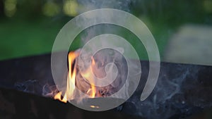 Handheld shot of charcoal in brazier, preparation for bbq photo