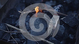 Handheld shot of charcoal in brazier, preparation for bbq photo