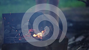 Handheld shot of charcoal in brazier, preparation for bbq photo