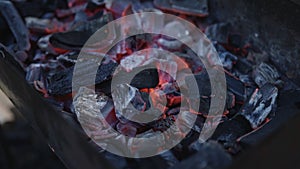 Handheld shot of charcoal in brazier, preparation for bbq photo